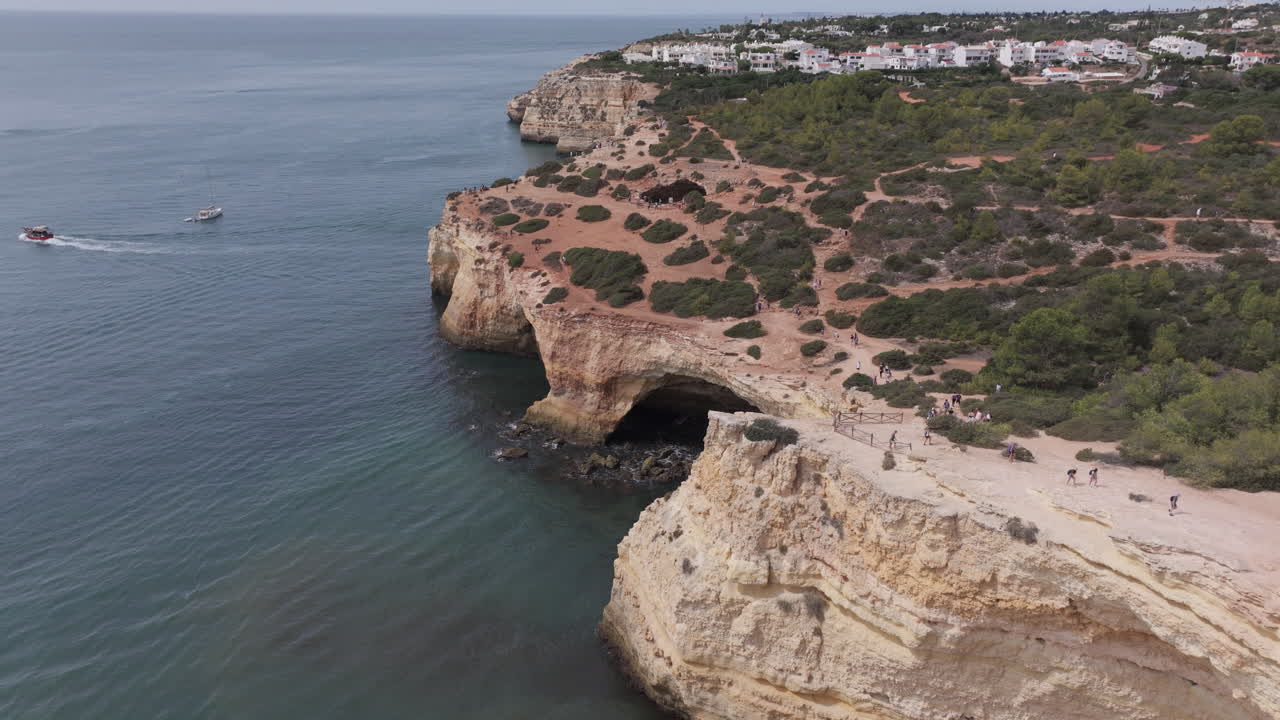 Aerial drone view of the Benagil Sea Cave and Atlantic Ocean coastline in Benagil, Algarve, Portugal, Europe. Afternoon in summer