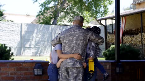 excited family meeting serviceman at home