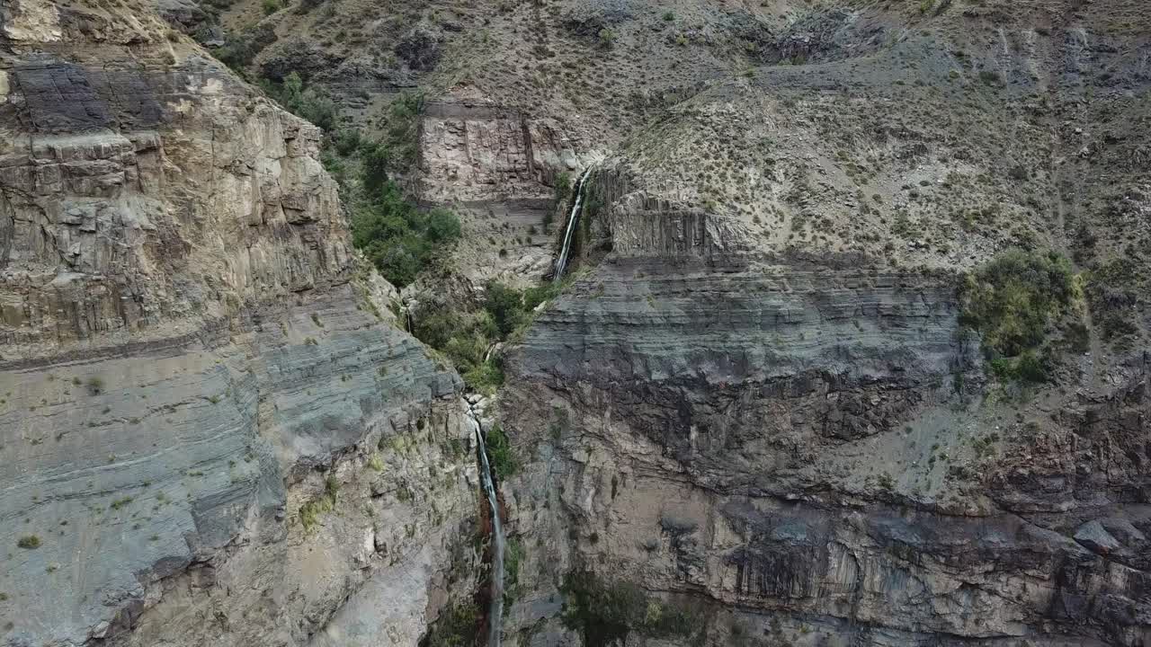 Freshwater Alpine Watefall on Steep Cliffs Under Andes Mountains, Chile. Drone Aerial View