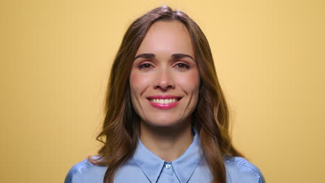 happy woman smiling at camera. positive woman standing in studio