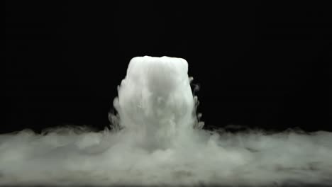 cognac glass with the effect of white dry ice at black background