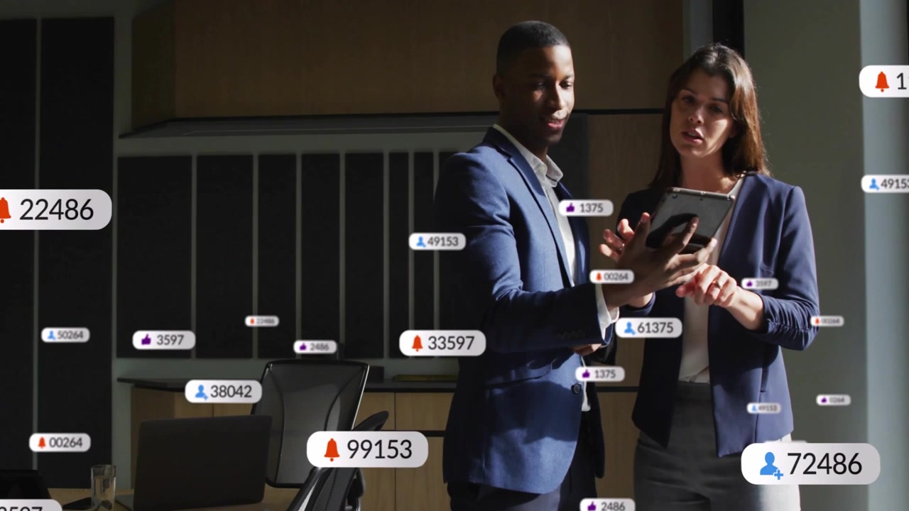 Woman tapping tablet and man holding it, initiating business badges and metric callouts multiplying