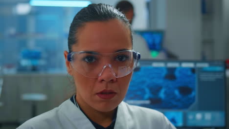 Close-up-of-tired-scientist-doctor-looking-at-camera-smiling