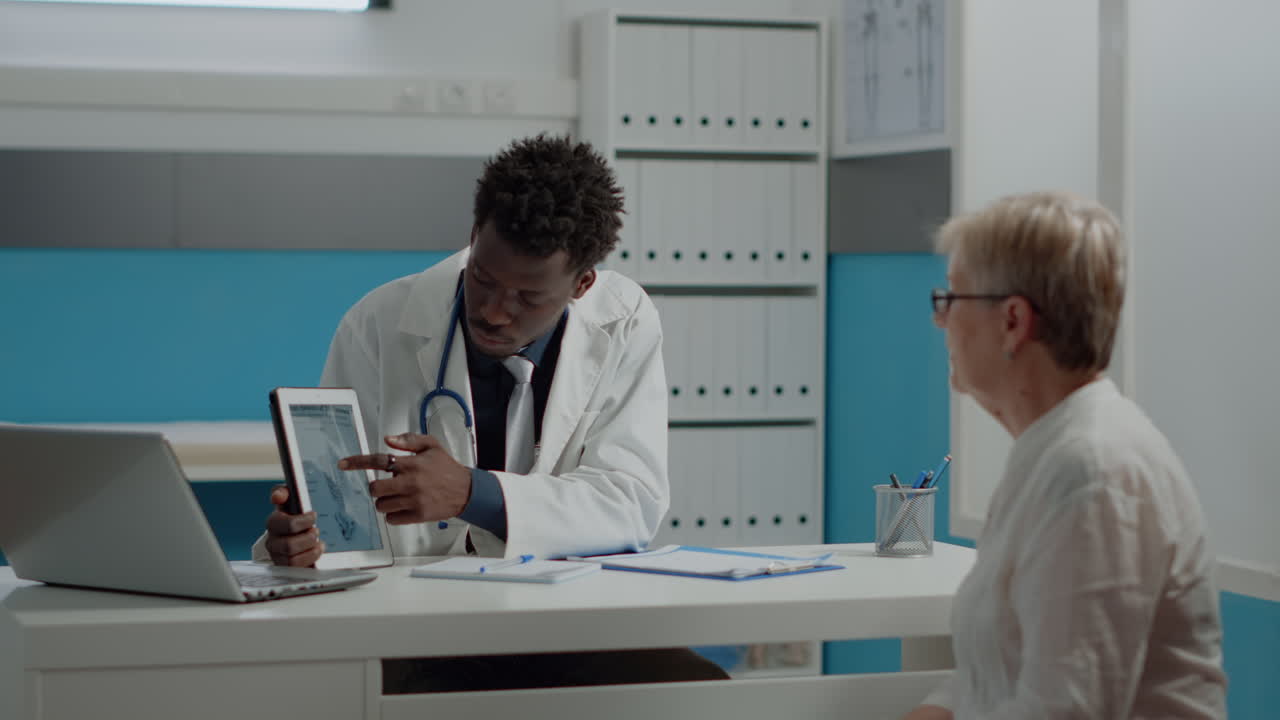 Medic of african american ethnicity holding tablet