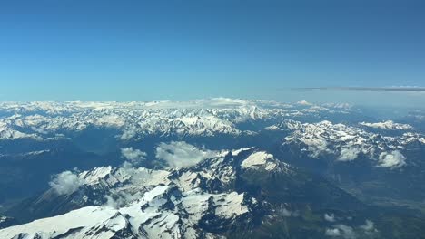 elevated aerial pov of the alps range shot from an airplane flying northbound at 10000m high