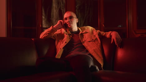 man on a couch talking on the phone
