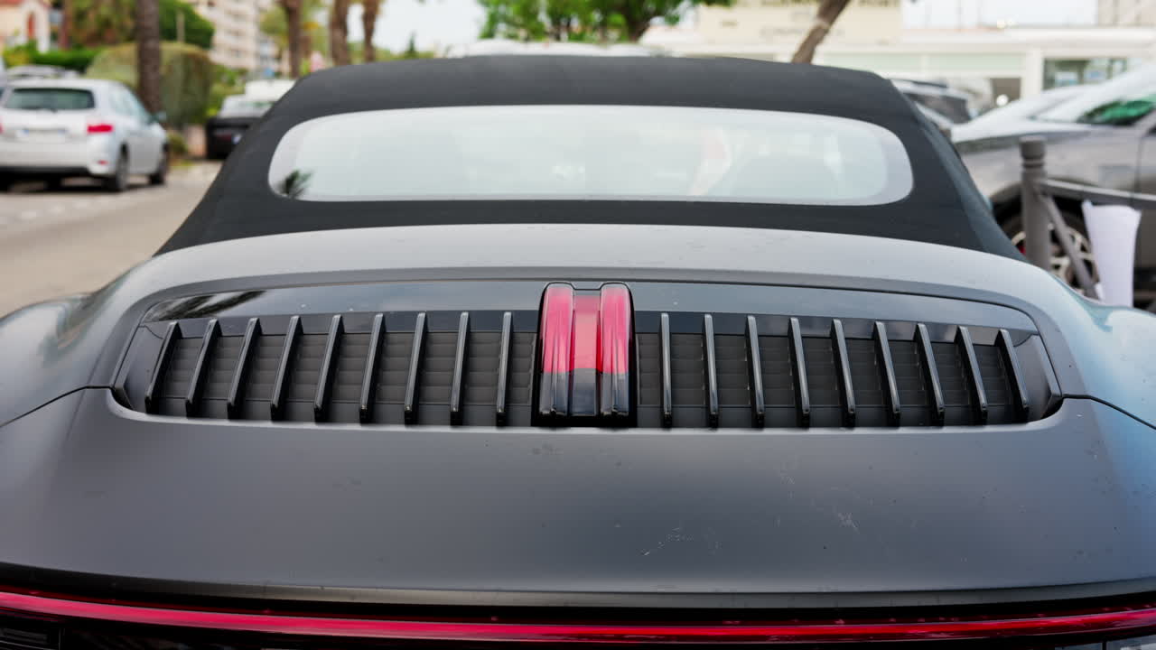 Close up of the back of a black convertible car on the street