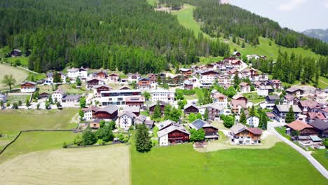 aerial view of la villa village in south tyrol, italy, with stunning green landscapes and majestic mountains in the backdrop