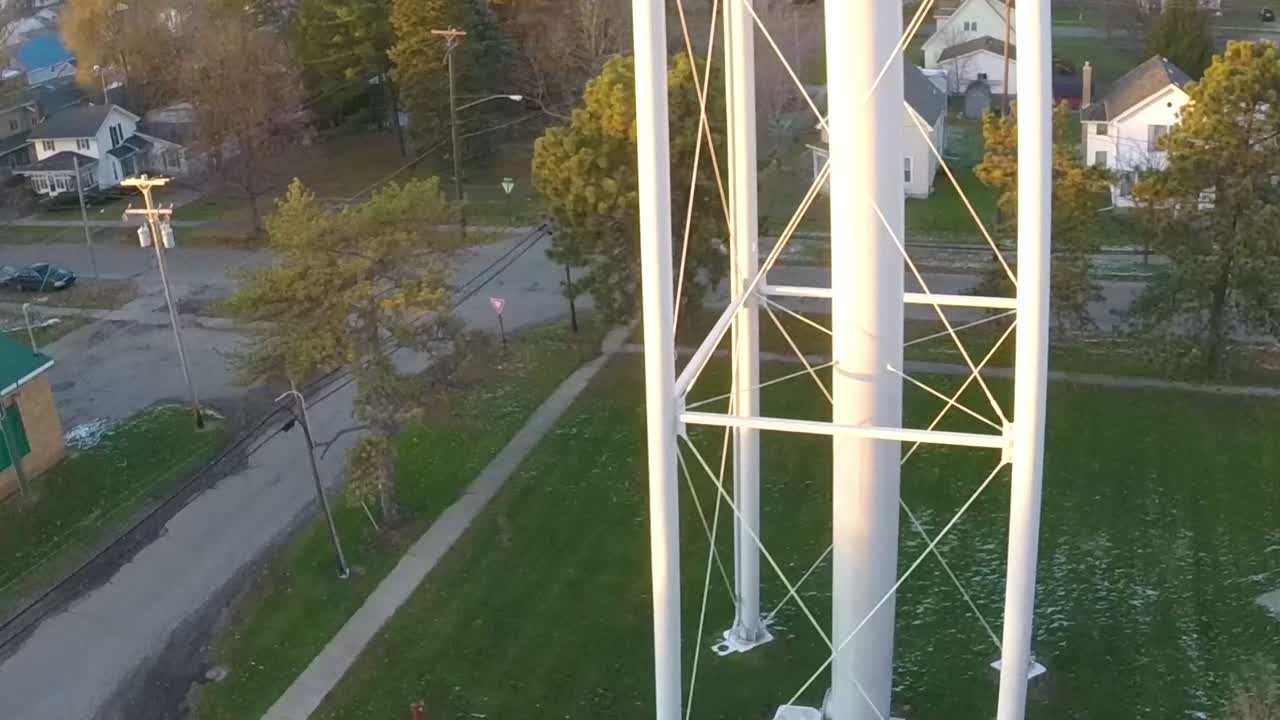 Aerial drone of a water tower in the small town of Ovid, Michigan at sunset