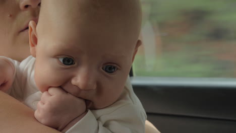 quiet baby traveling by car with mum