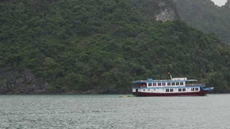 cruise ship sailing through ha long bay in vietnam