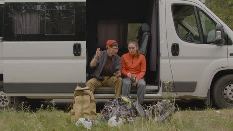 heterosexual couple sitting in a van