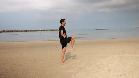 backdrop of the ocean a mature male doing lunges and exercises to stay fit