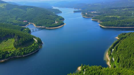 aerial drone footage of a oasa lake from sureanu mountains, alba county, transalpina, transylvania, romania