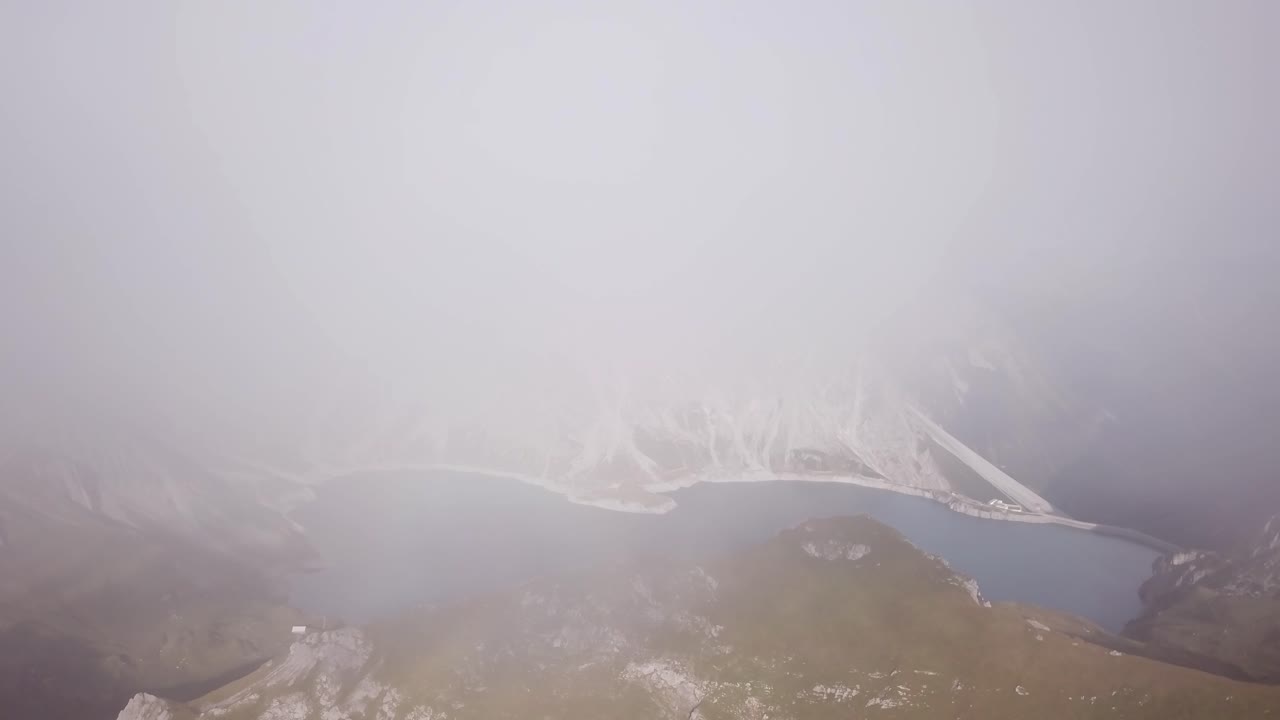 Foggy Drone flight in Alps Lünersee Lake in Austria Vorarlberg