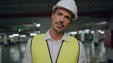 handsome contractor looking camera at parking lot portrait. serious man closeup
