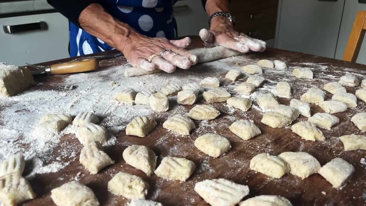 Closeup Slow motion italian hands cook Gnocchi dumpling cuisine traditional dish pasta, dough of wheat flour