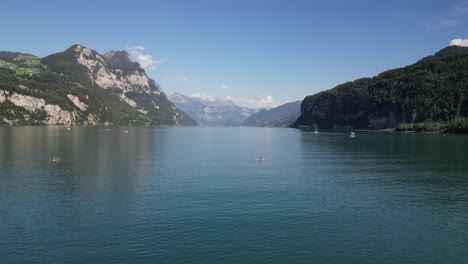 middle of the massive river moving forward through the giant mountains area filled with plenty hills covered with stone peaceful calm environment love our planet boats and surfers hanging around sunny