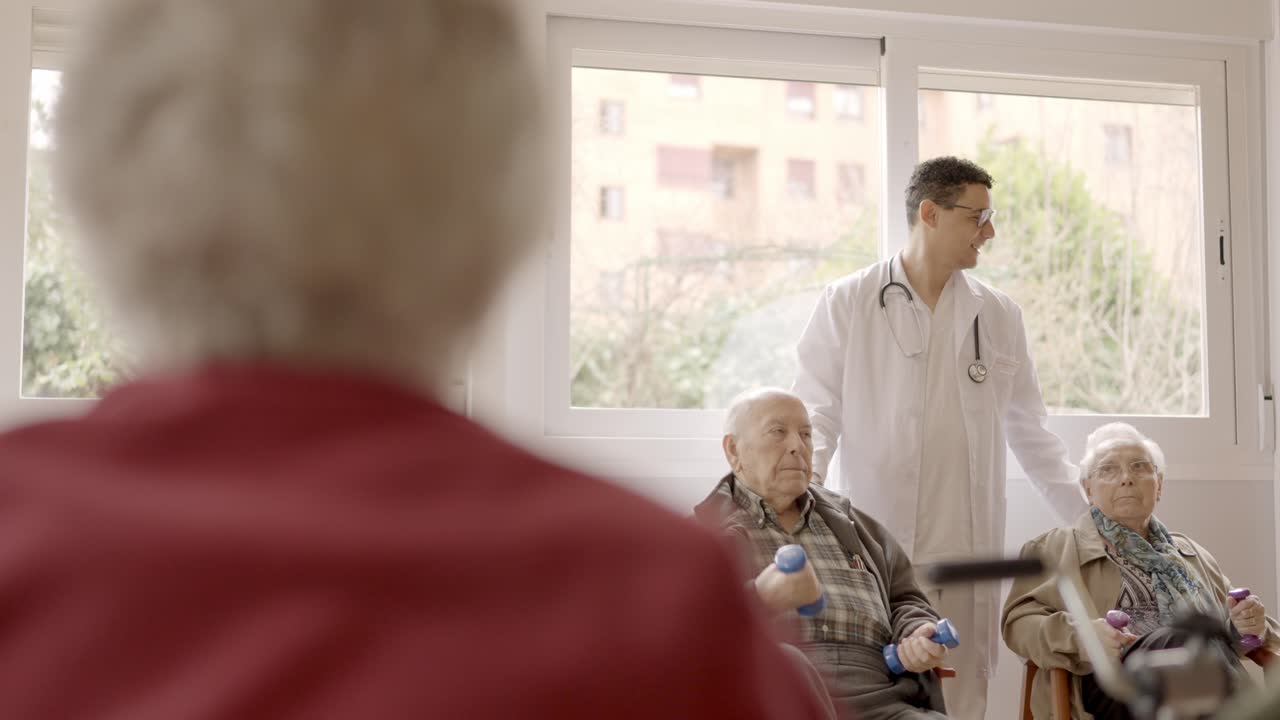 Senior people exercising with dumbbells in a nursing home