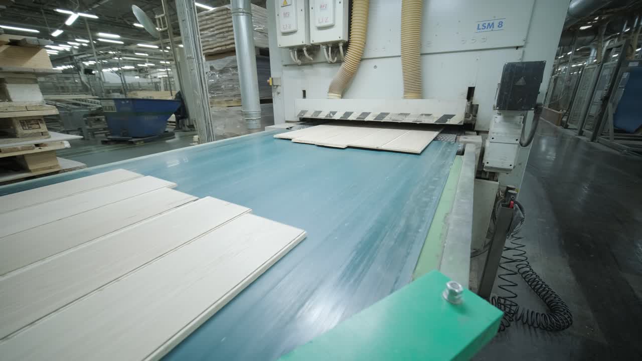 Wooden Planks Moving on an Industrial Conveyor Belt in a Factory