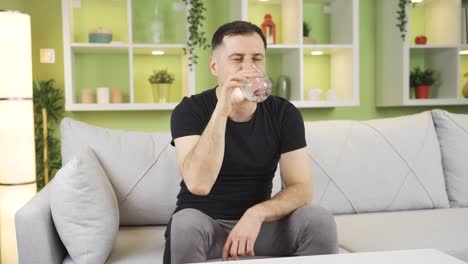 a happy man who drinks water for healthy and happy life.