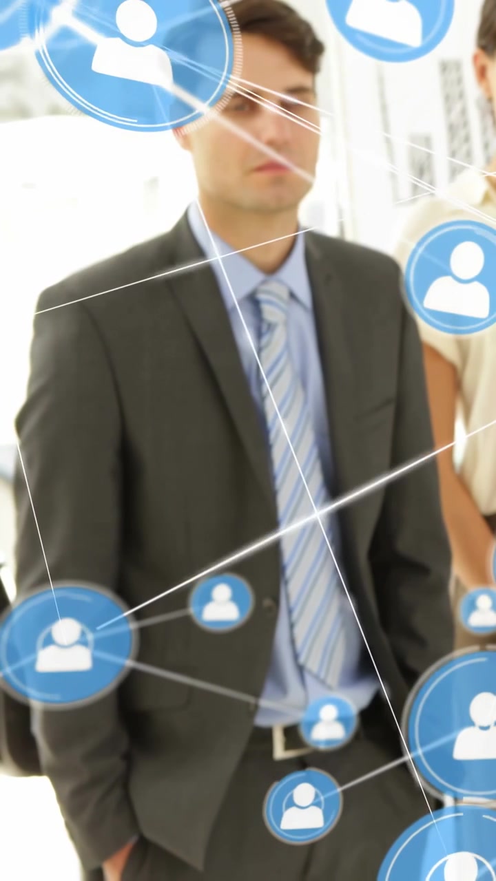 Vertical video: Man in suit and woman in office cam starting blue icons hiding faces for marketing