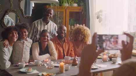 happy large family posing for group photo at holiday dinner