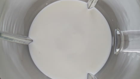 blender mixing organic milk in super slow motion close up. protein ingredient