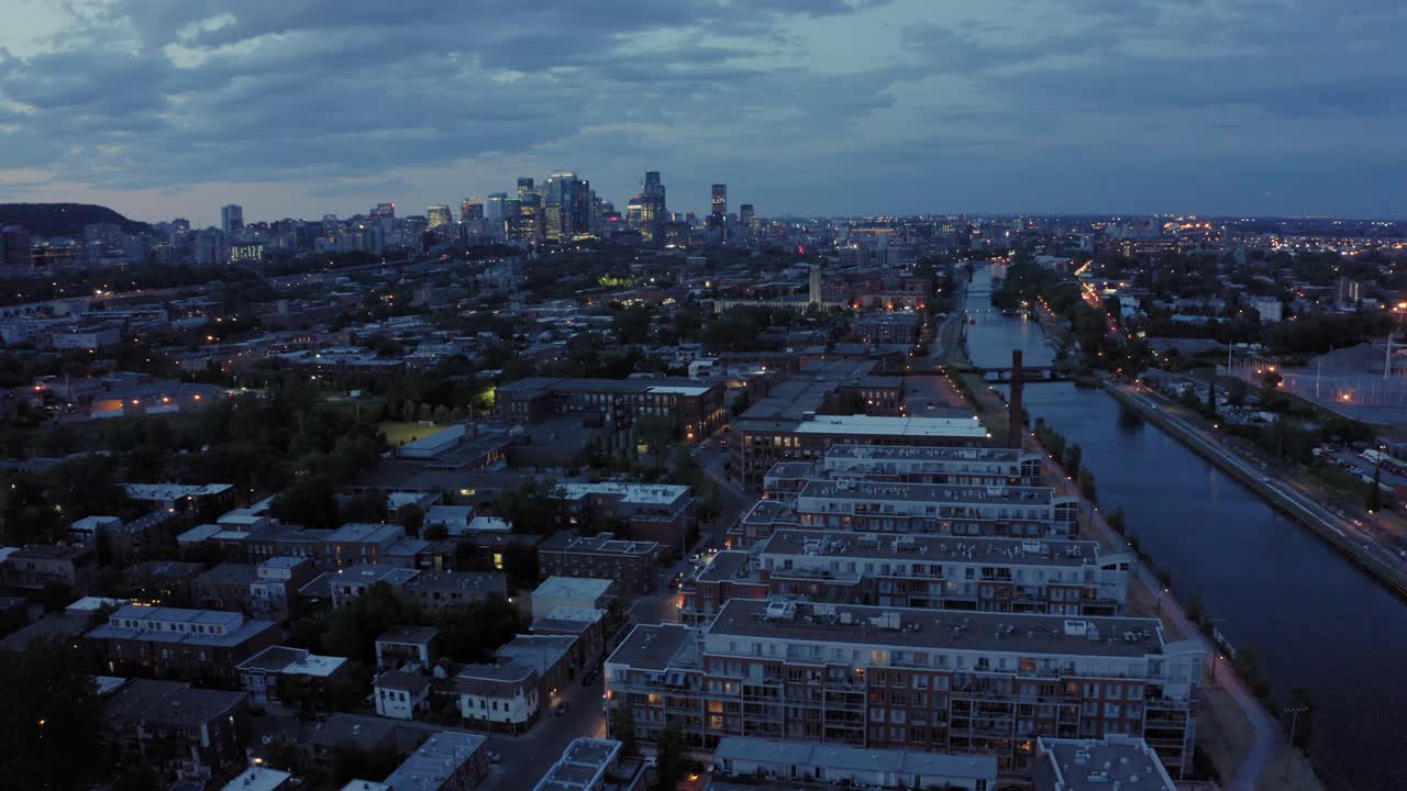 Aerial shot moving up, showing Montreal's downtown at dusk showing a dramatic sky and skyline