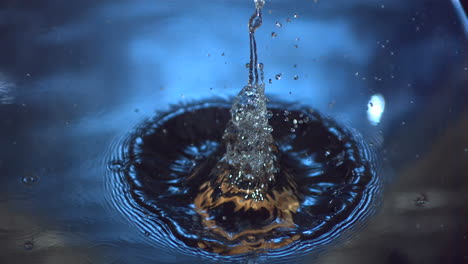 Wooden-ring-falling-into-blue-water-