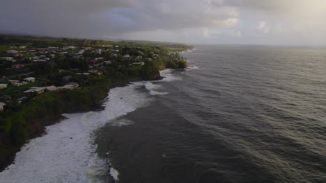 aerial slide and pan footage of ocean coast and waves on water surface