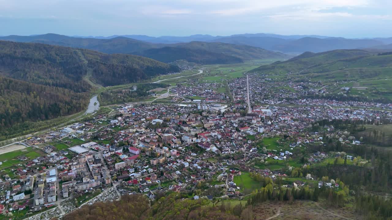 Drone view of Gura Humorului city at sunset with hills