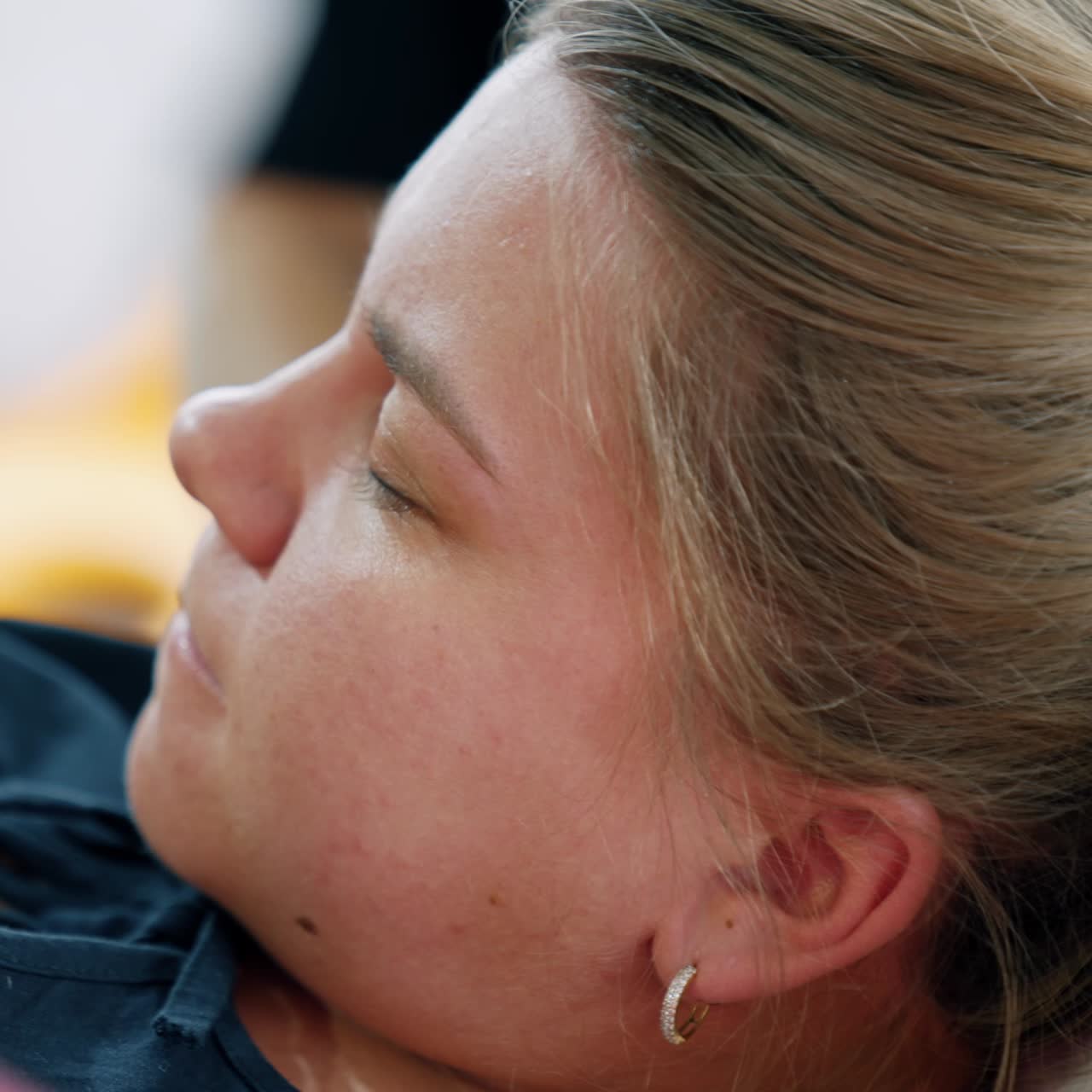 Face of a woman during labor. Pregnant lady closed her eyes feeling pain. Close up portrait