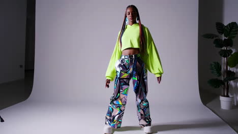 fashionable woman in neon cropped top and colorful pants