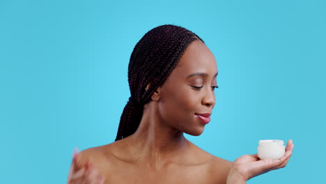 african woman, skincare cream and studio
