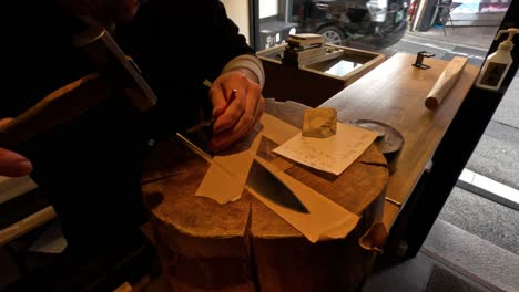 craftsman engraving names on knives in kyoto store