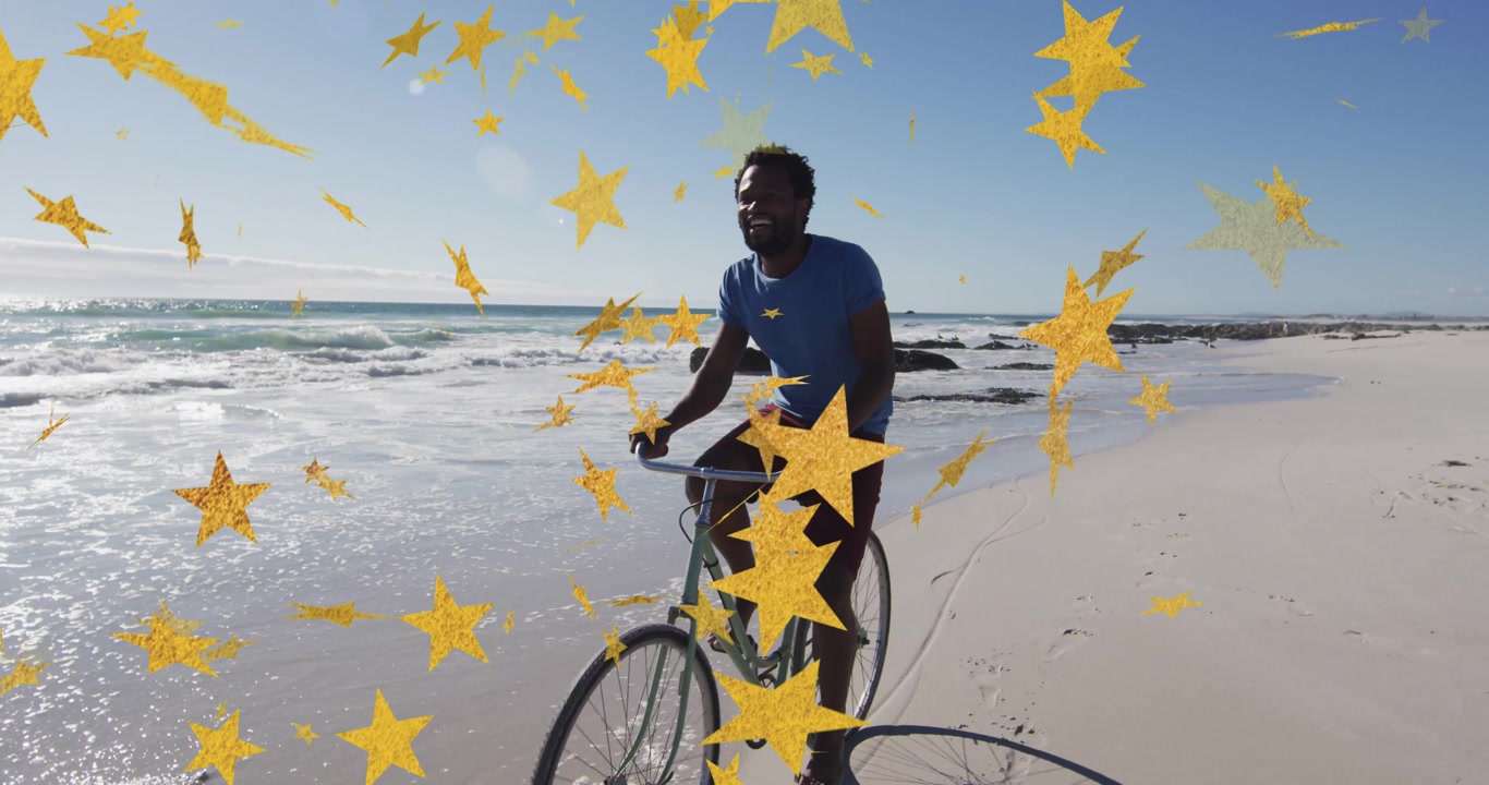 Male rider rolling bicycle on wet sand creating wave splashes, drifting star overlay for marketing