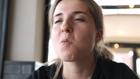 young woman relishing a juicy burger while expressing delightful emotions