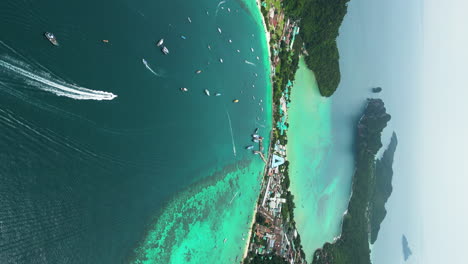 vertical video of a lagoon full of boats and yachts on phi phi islands, thailand