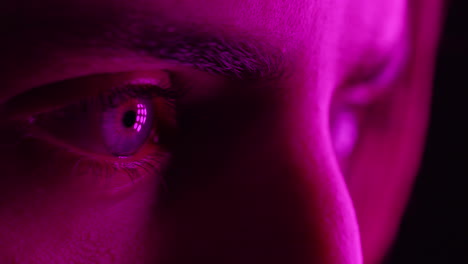 colorful macro eyes young man hallucinating intense drug addiction with multicolor light flashing emotions concept