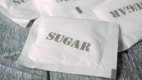 white sugar in a paper packet on table ,