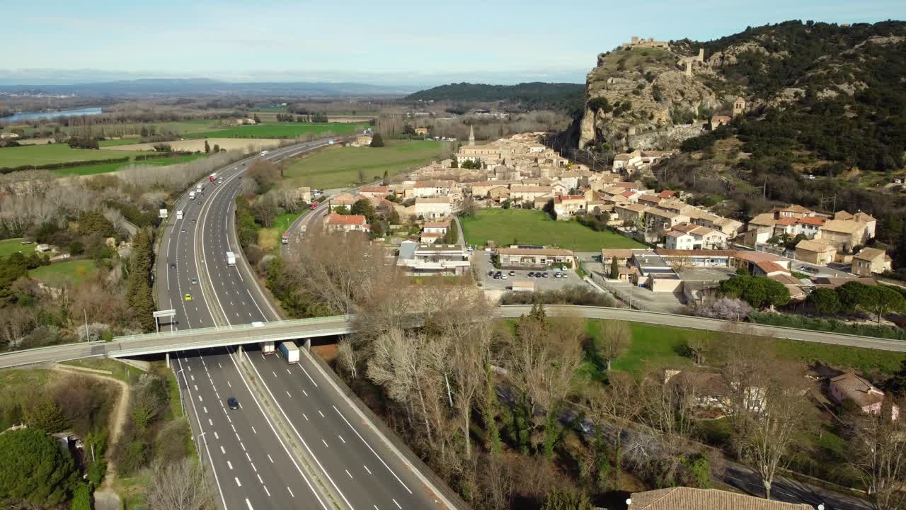 Aerial view of village near highway with mountains and castle