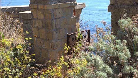 High-angle-shot-of-scenic-viewpoint-over-rocky-cliff-in-Procida-island,-Cordicella-area-in-the-neighborhood-in-Bologna,-Italy-on-a-sunny-day