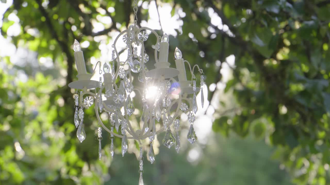 Outdoor wedding decoration. Elegant crystal chandelier. Zoom