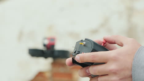 hands of the pilot of the cinedrone with the control panel in the background you can see a flying dr