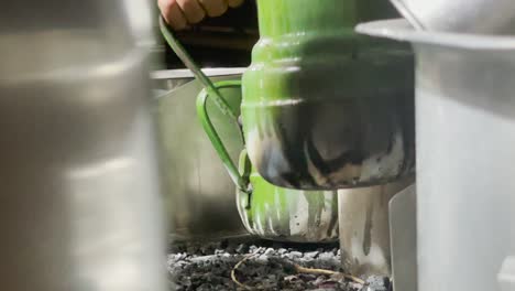 Close-up-shot-of-tea-kettles-in-a-roadside-tea-stall-in-Karachi,-Pakistan-at-night-time