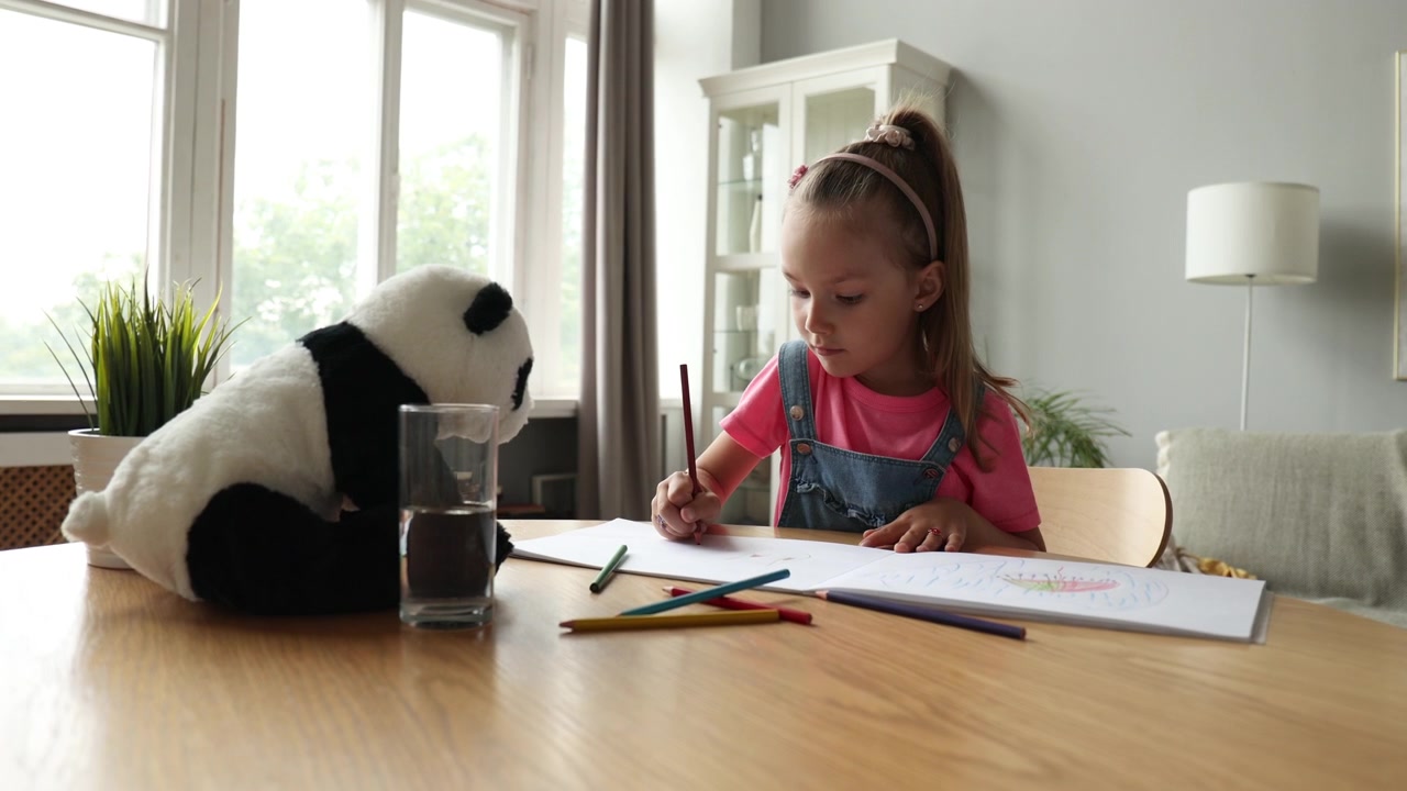 Young Girl Drawing and Coloring with Pencils at Home