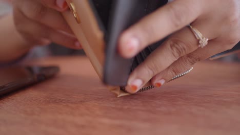 woman opening a wallet and purse