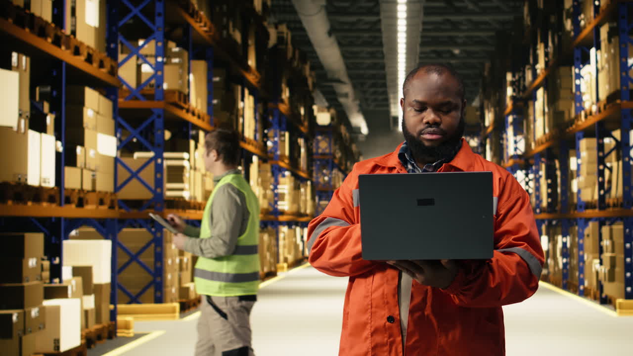 African american staff overseeing order fulfillment packages for dispatch