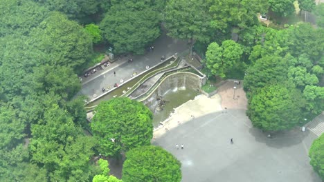 still aerial view close up waterfall in park with people